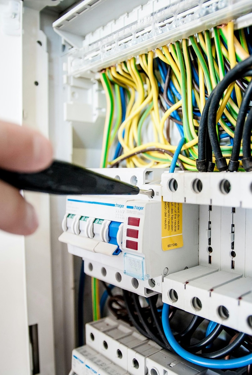 Electrician working on electrical circuit breaker panel