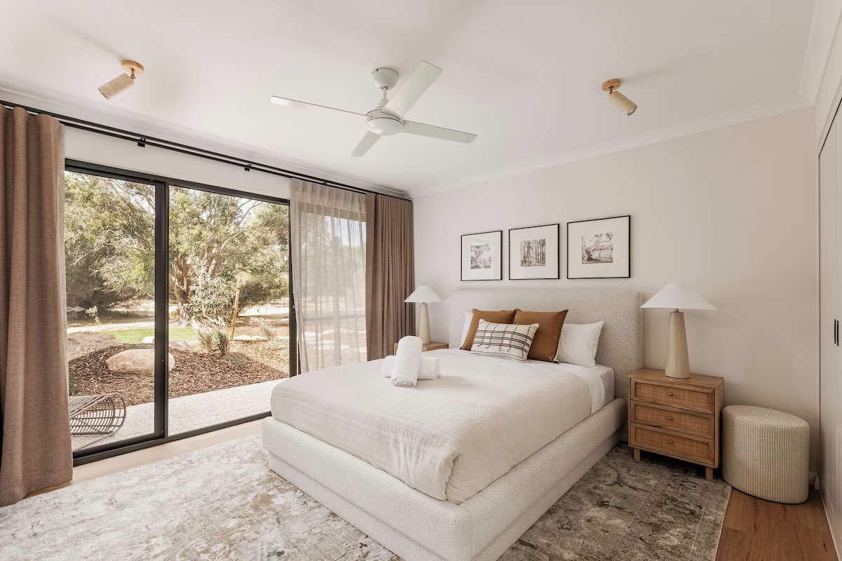 Modern bedroom with large windows and neutral decor